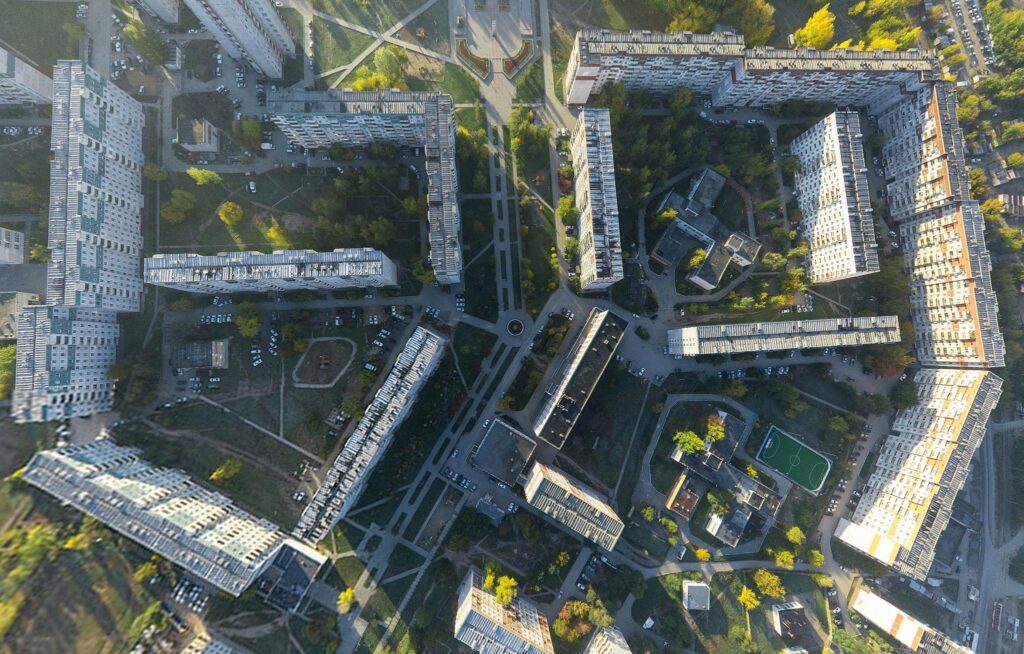 Aerial city view with crossroads, roads, houses, buildings and parks